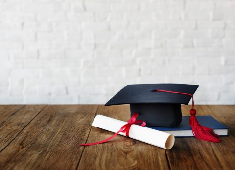 Mortar board and a graduation diploma
