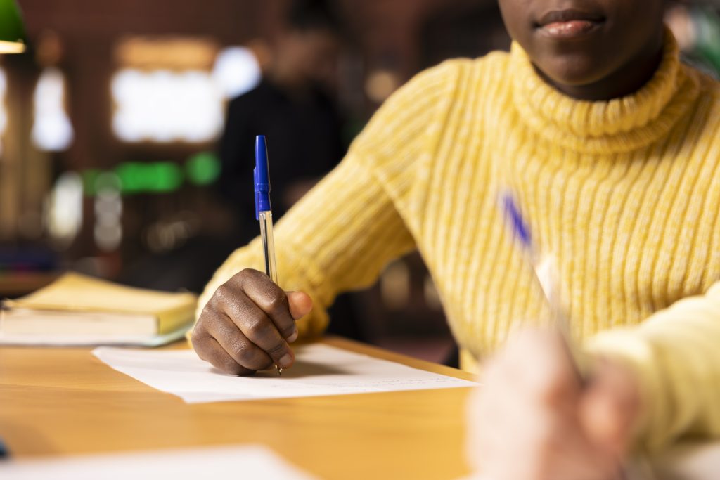 Diverse classmates brainstorming and writing ideas for a project