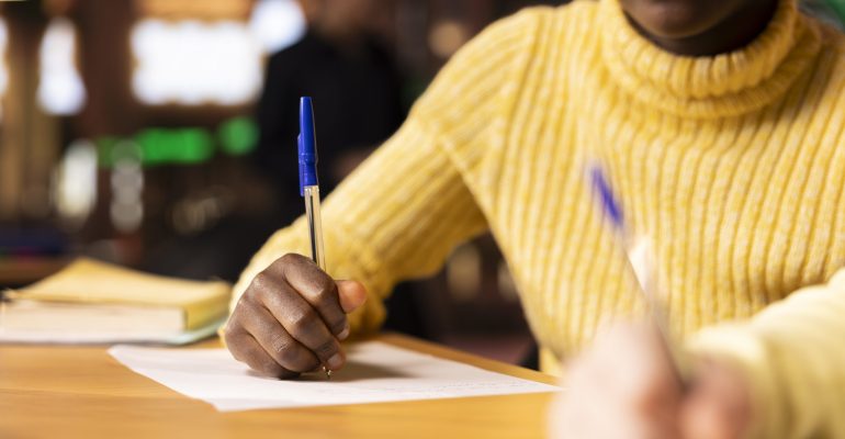 Diverse classmates brainstorming and writing ideas for a project