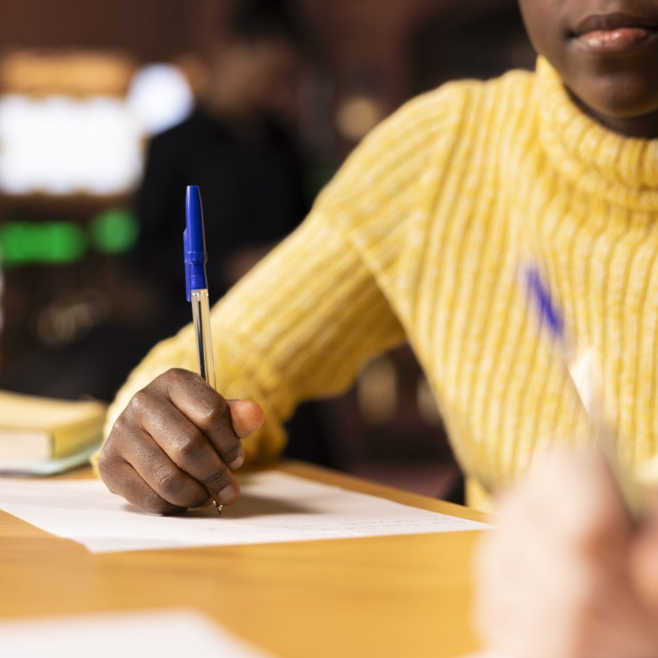Diverse classmates brainstorming and writing ideas for a project